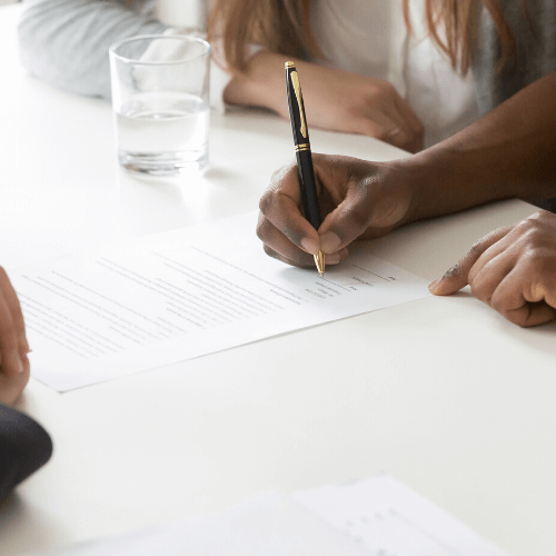 A couple signing a prenuptial agreement